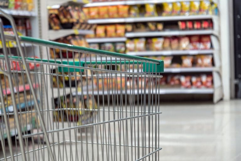 Closeup the trolley for shopping over the store blurred in department store bokeh background